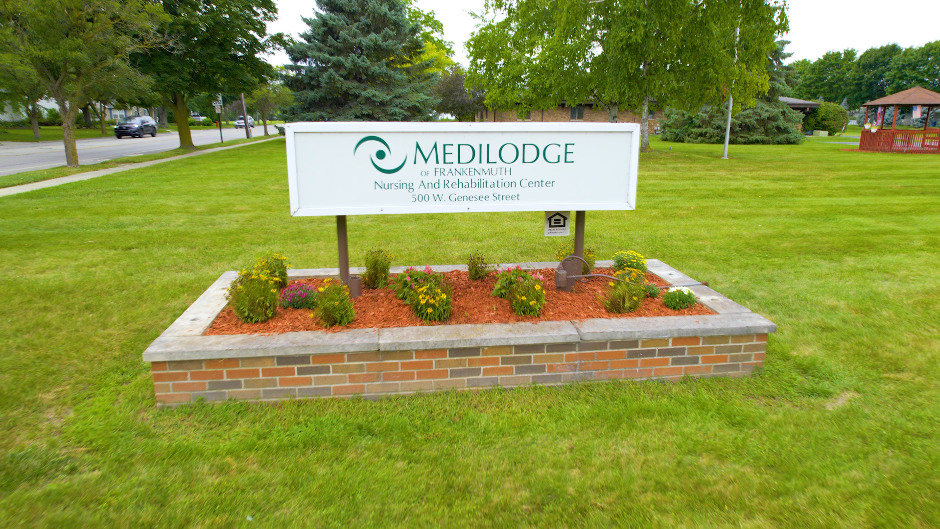 Medilodge of Frankenmuth sign board with trees in the background.